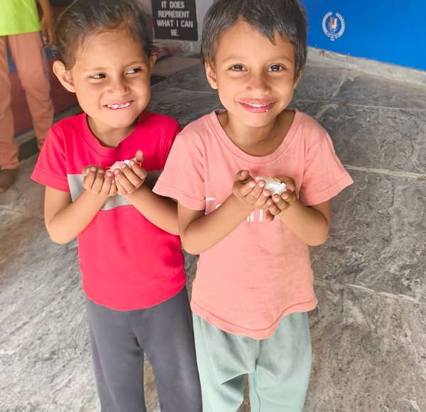 Children smiling at a Pehal Sanstha programme